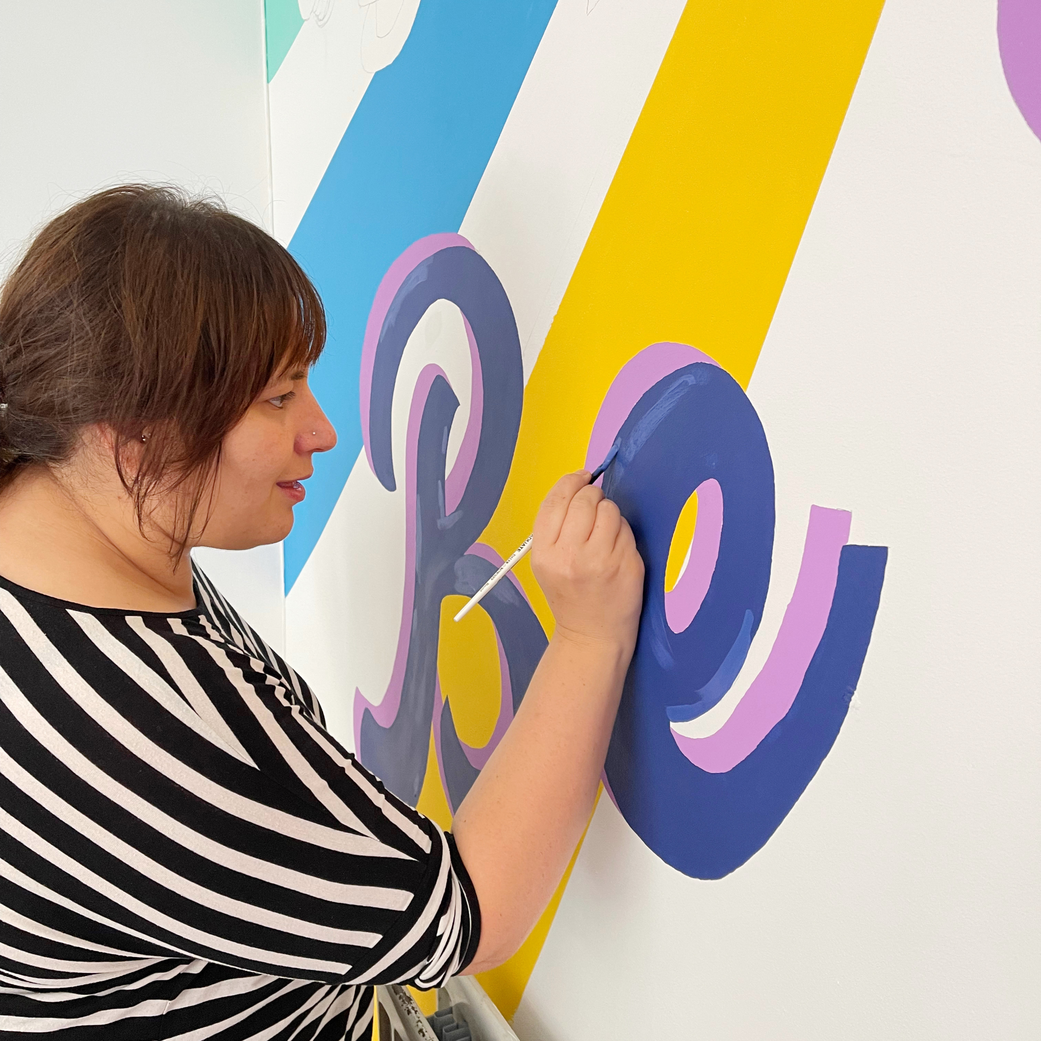 Daria painting the mural